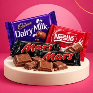Cadbury Dairy Milk, Nestlé and Mars chocolate on a pink background